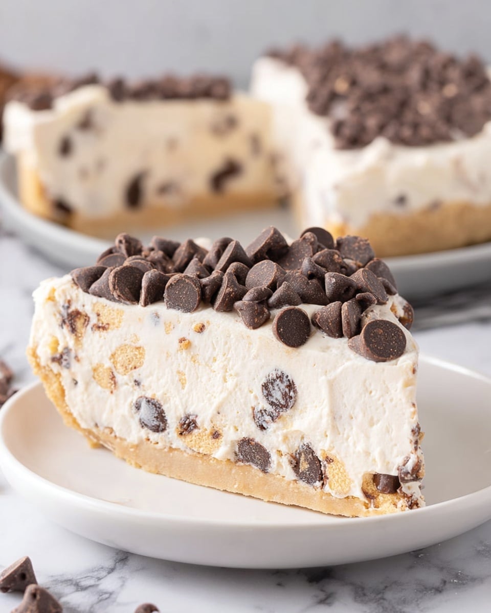 A slice of dessert with three layers is on a white plate resting on a white marbled surface. The bottom layer is a light tan, firm-looking crust, the middle layer is creamy white with small dark chocolate chips inside, and the top layer is smooth white frosting covered with numerous dark chocolate chips. Near the plate, there is a gold fork holding a bite-sized piece of the dessert, highlighting the same layers. Another white plate with a similar slice is partially visible in the background, along with a small pile of chocolate chips and a mustard-colored cloth nearby. Photo taken with an iphone --ar 4:5 --v 7