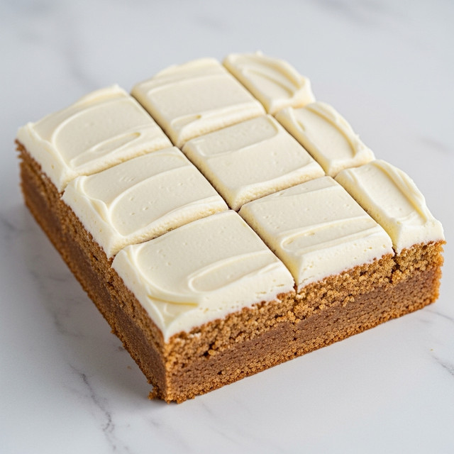 The image shows nine square pieces of a cake arranged in a 3x3 grid on a white marbled surface. Each piece has two visible layers: the bottom cake layer is a warm brown color with a slightly rough texture, and the top layer is a thick, smooth, creamy beige frosting spread evenly with visible swirls and small specks. The edges of the cake pieces are cleanly cut, and one piece is slightly tilted, showing the thickness of both layers clearly. The overall look is simple and neat with no additional toppings or decorations. Photo taken with an iphone --ar 4:5 --v 7