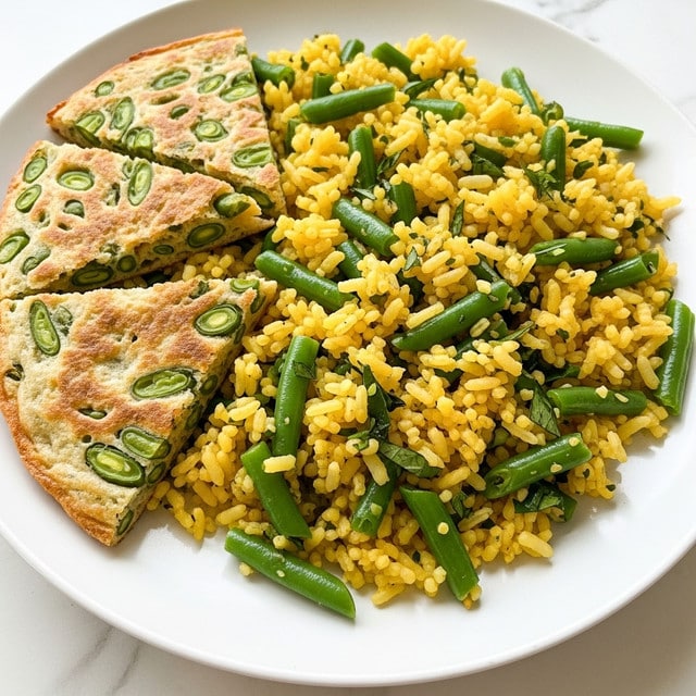 A close-up of a white plate filled with a colorful rice dish mixed with bright green beans and tiny bits of herbs scattered throughout. The rice is a mix of white and yellow grains giving a dotted texture and color contrast. On the left side of the plate, there are three triangular pieces of a crisp, golden-brown tortilla-like side with a slightly textured surface showing the embedded green beans. The plate rests on a white marbled texture surface. photo taken with an iphone --ar 4:5 --v 7