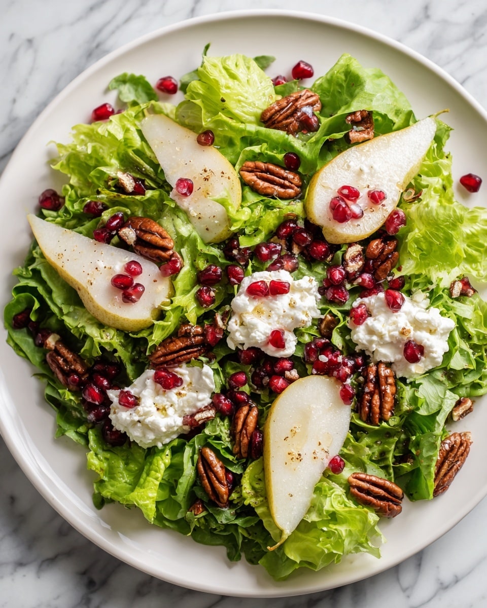 A fresh salad is shown on a white plate, starting with a base layer of bright green lettuce leaves that have a crisp texture. Scattered over the lettuce are dark red pomegranate seeds and pecans, giving a rich brown contrast with a slightly rough texture. Small white dollops of creamy goat cheese rest on top of the greens, some of which are drizzled with a light golden honey or dressing. Pieces of light brown pear add a soft and smooth texture, placed evenly around the salad. The surface beneath the plate is a white marbled texture. photo taken with an iphone --ar 4:5 --v 7